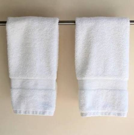 White hand towels hanging on a rail
