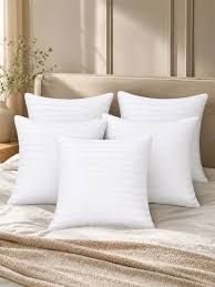 White cushions styled on a bed